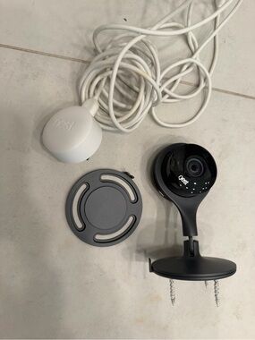 Nest Indoor Security Camera with White Power Adapter and Black Camera